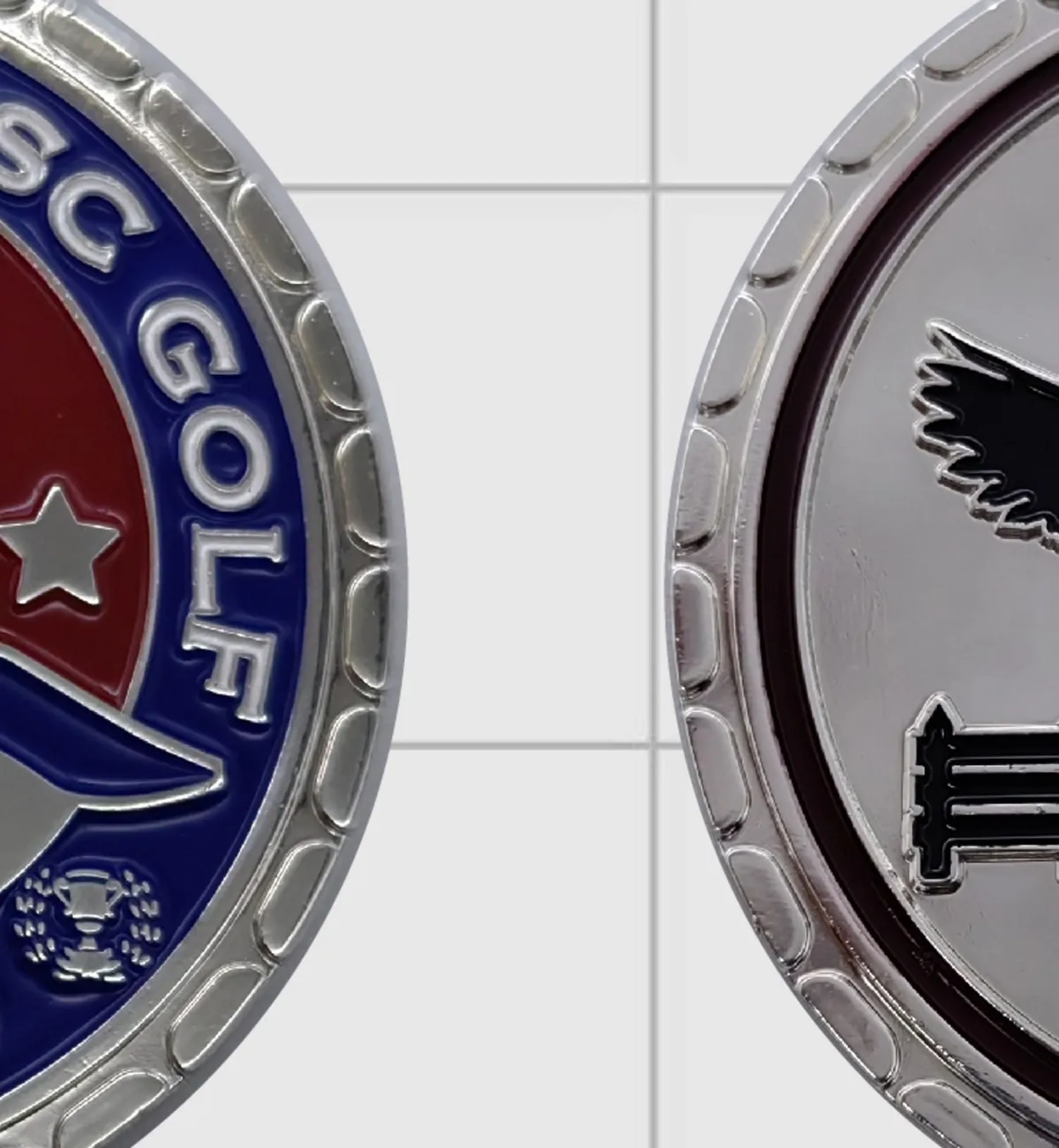 Photo of the finished challenge coin, the enamel crest in navy and red with a silver rim.
